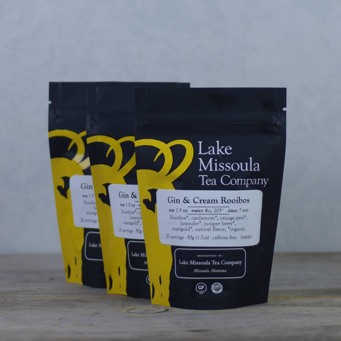 Lake Missoula Tea Company's Gin & Cream flavored tea in a clear tea bag with visible tea leaves and cream-colored infusion.