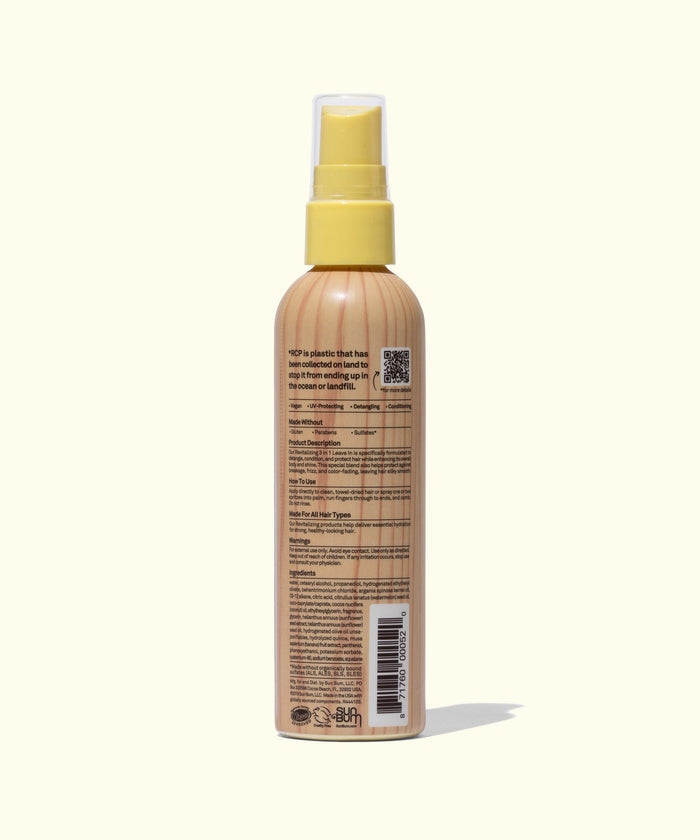 Back view of Sun Bum 3 In 1 Leave In spray bottle showing label details and text on beige background