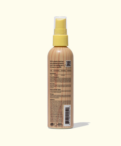 Back view of Sun Bum 3 In 1 Leave In spray bottle showing label details and text on beige background