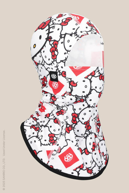 The 686 Alpha Hinged Balaclava by 686 features multiple Hello Kitty faces with red bows on a white background, styled as a ski mask and shown on a beige backdrop.