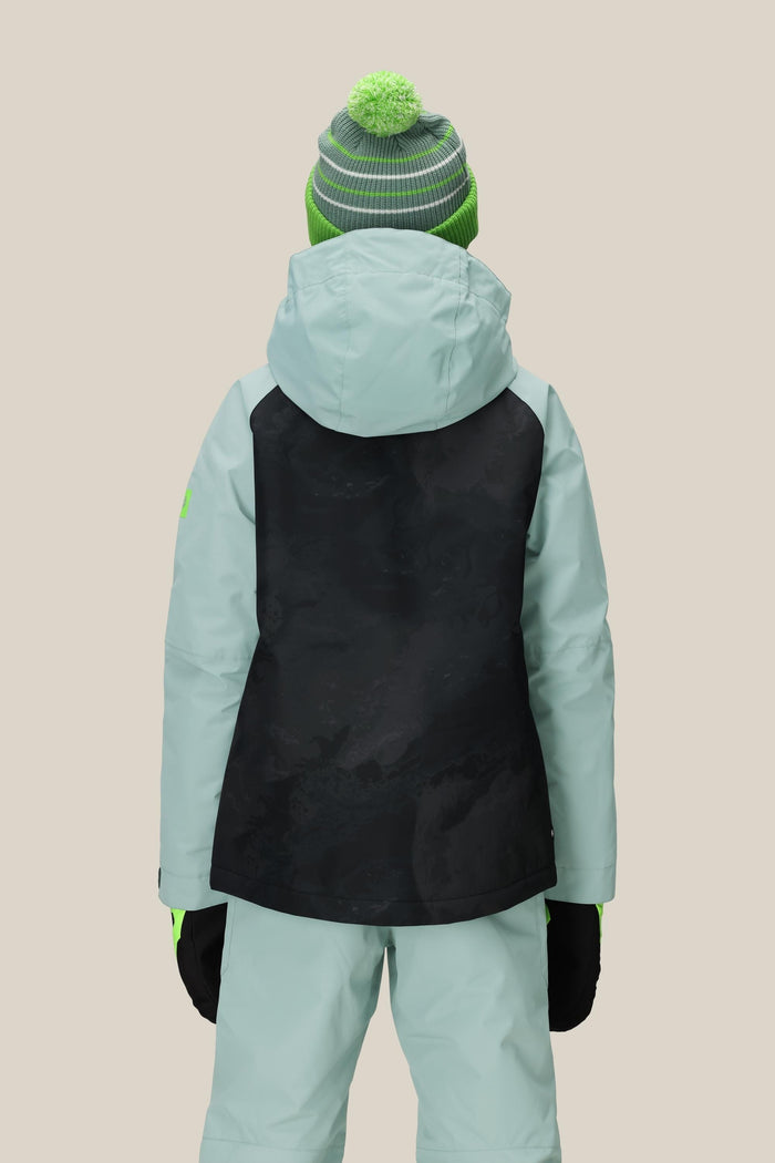 A person is shown from the back wearing a 686 Boys' Hydra™ Insulated Jacket by 686 in light blue with a black back panel, light blue pants, black gloves, and a green/gray striped beanie with a green pom-pom against a beige background.