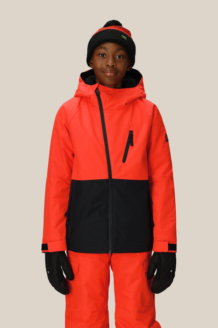 A young person wears the 686 Boys' Hydra™ Insulated Jacket by 686, paired with matching red snow pants, black gloves, and a black beanie with a red stripe, standing against a plain light background.