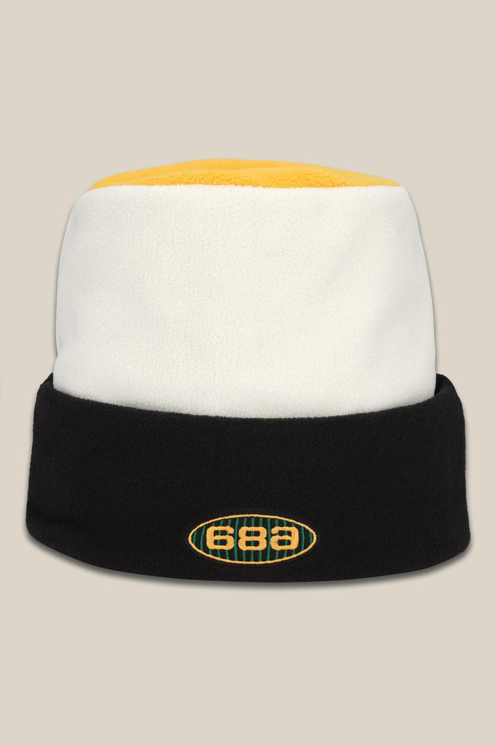 The 686 Flatop Fleece Hat is a men‚Äôs knit beanie by 686 featuring a yellow top, white middle, black fold-over brim, and an oval front logo displaying the numbers 686.