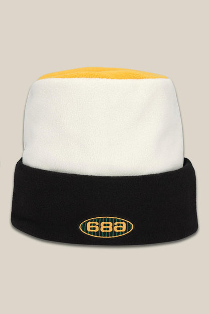 The 686 Flatop Fleece Hat is a men‚Äôs knit beanie by 686 featuring a yellow top, white middle, black fold-over brim, and an oval front logo displaying the numbers 686.