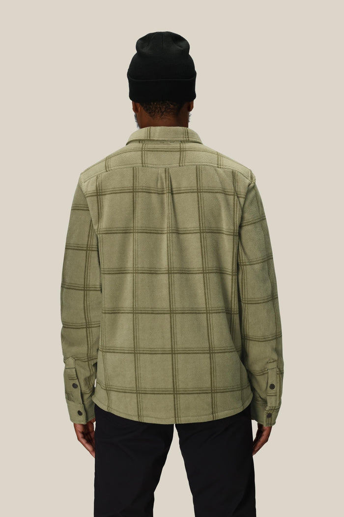 A person is shown from the back, wearing the 686 Mens Sierra Fleece Flannel and a black beanie against a beige background‚Äîthis 686 piece is the perfect spring riding layer.