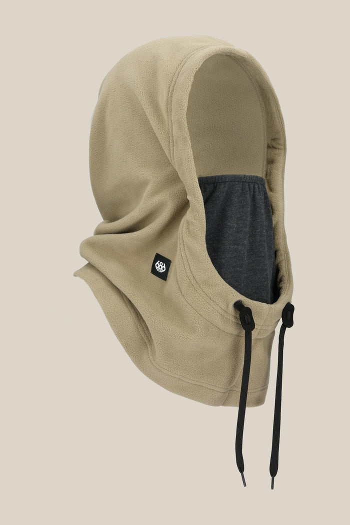 The 686 Tarmac Fleece Hood by 686 features a beige design with black drawstrings, a small black side logo patch, and a dark gray inner lining‚Äîideal for anyone looking to add a stylish accessory to their hoodie collection.