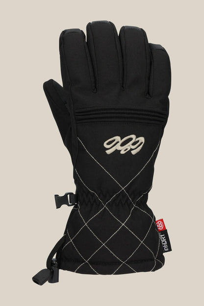 The 686 Women's Jubilee™ Glove is a black winter glove featuring white diamond stitching, an embroidered 686 logo, an adjustable wrist strap with clip, and a red and gray side tag.