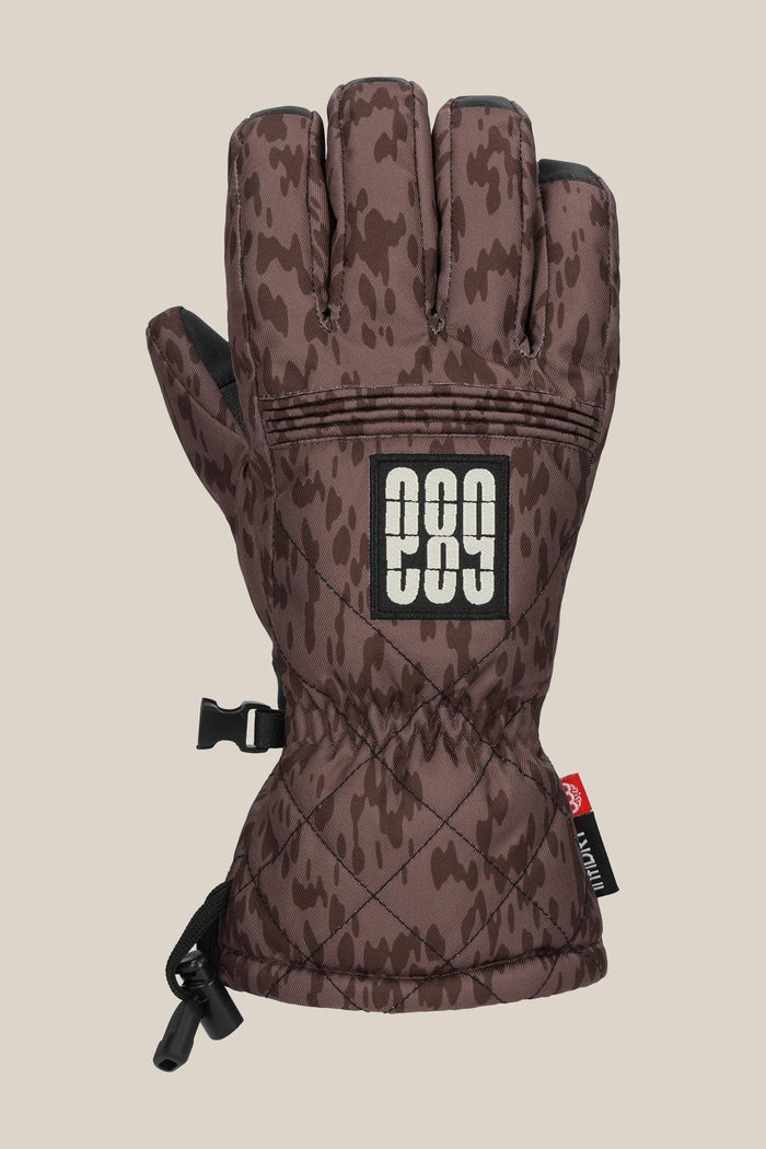 The 686 Women’s Jubilee™ Glove features a brown camo pattern, black and white "686" logo patch, quilted wrist design, and an adjustable strap. Shown palm down on a neutral background.