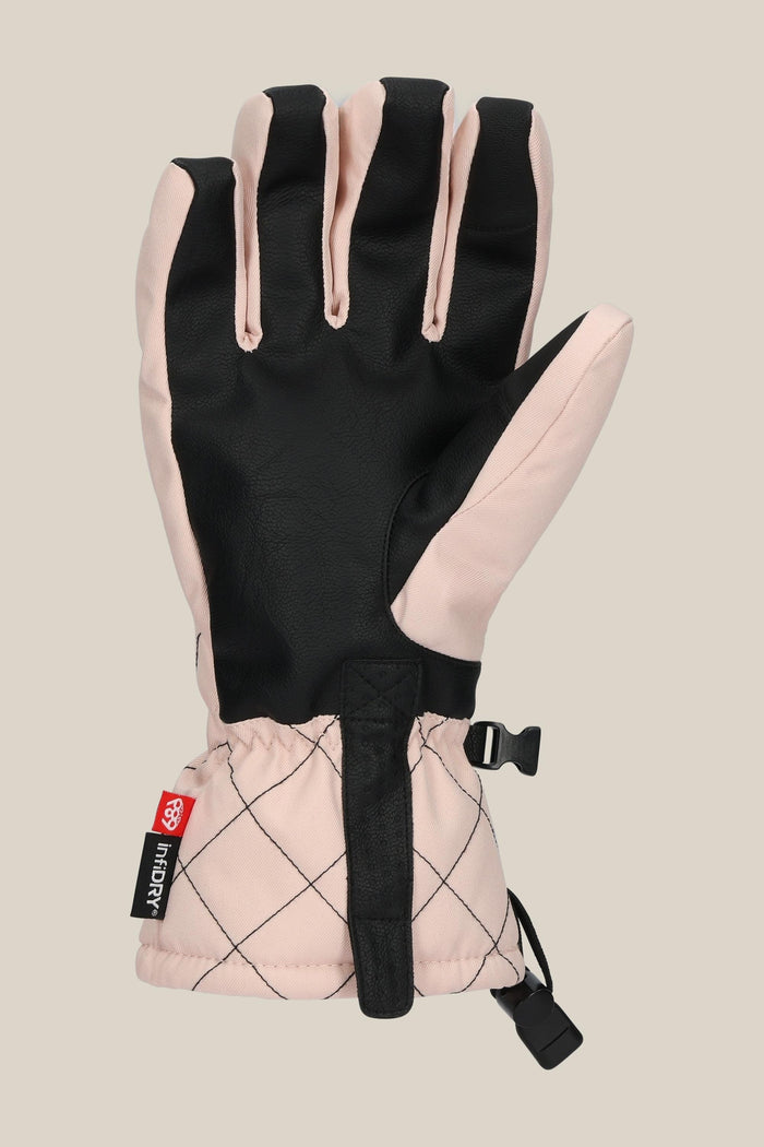The 686 Women's Jubilee™ Glove is shown palm-side up with a black palm, light pink quilted back, adjustable wrist strap, and a small red and black side tag.