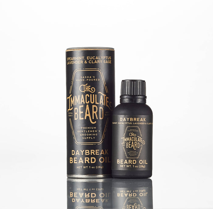 The Immaculate Beard Twilight Beard Oil bottle with dark amber liquid and black cap, placed on a wooden surface.