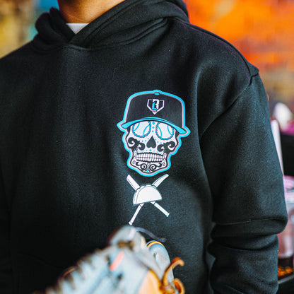 Black hoodie with a skull and crossbones design, worn by a person.