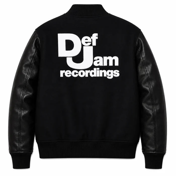 Front and back catalog layout of the Leveljacket Def Jam Recordings black varsity jacket, displaying a premium black wool body with black leather sleeves, custom white embroidered turntable needle art on the front chest, and a bold white Def Jam Recordings typography patch layout across the back.