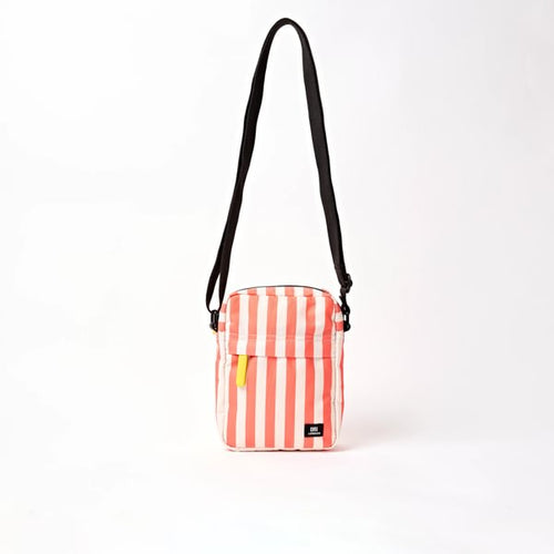Canvas crossbody bag with coral-and-white stripes, zip top, and adjustable black strap