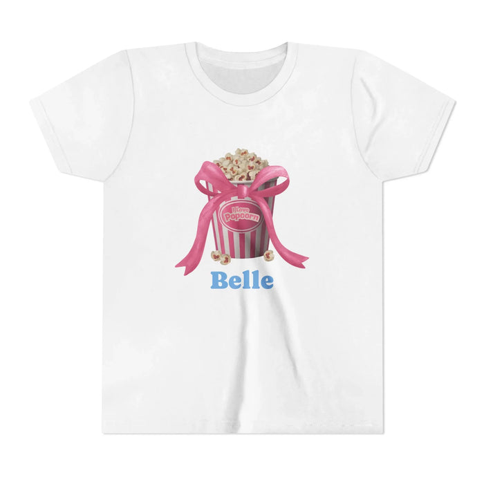 White t-shirt with popcorn bucket graphic, pink ribbon, and blue text 'Belle'