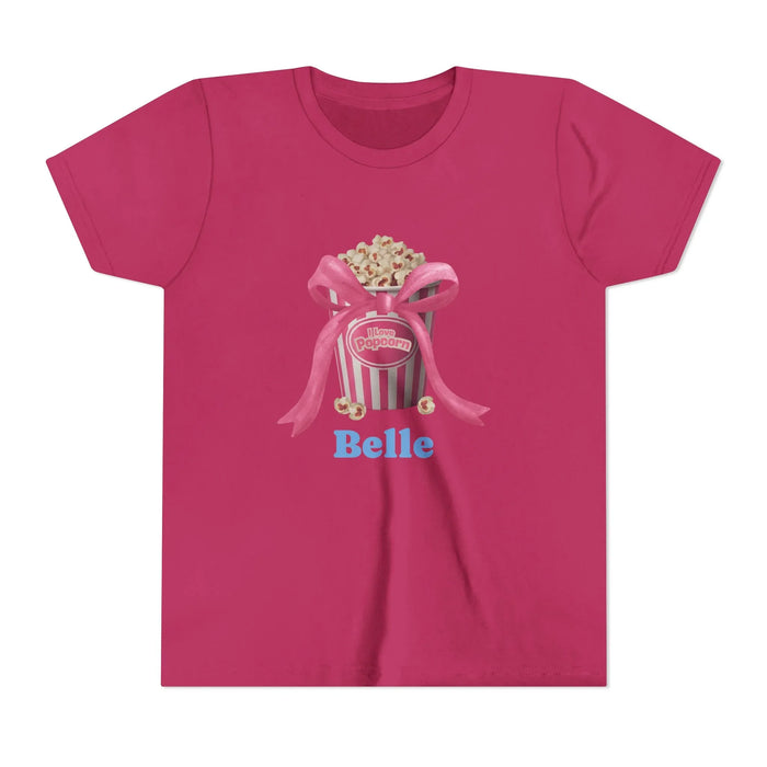 Magenta T-shirt with popcorn bucket graphic tied with pink bow and text 'I love Popcorn' and 'Belle'
