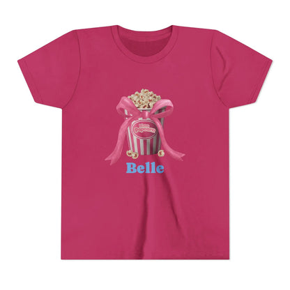 Magenta T-shirt with popcorn bucket graphic tied with pink bow and text 'I love Popcorn' and 'Belle'