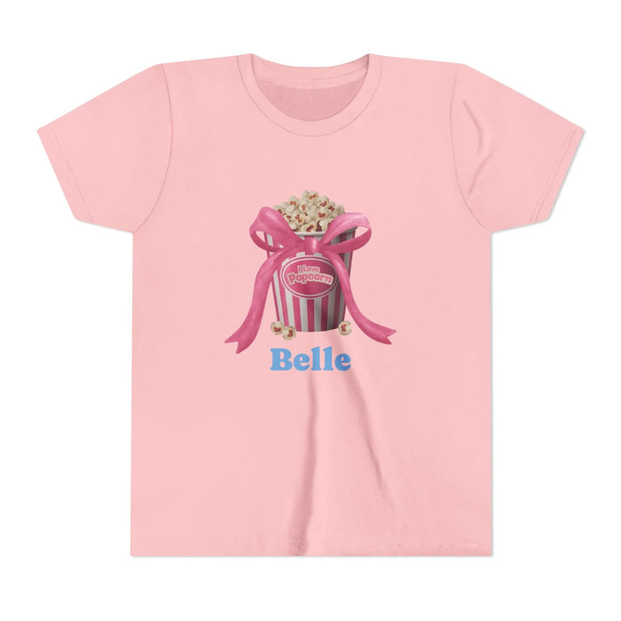 Pink t-shirt with popcorn bucket graphic tied with pink ribbon and blue text Belle