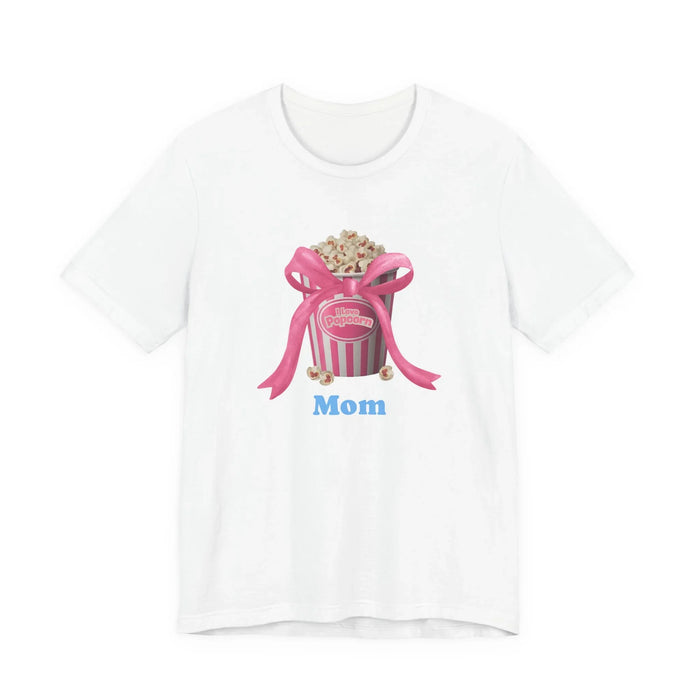 White t-shirt with pink popcorn bucket graphic, pink ribbon bow, and blue text Mom