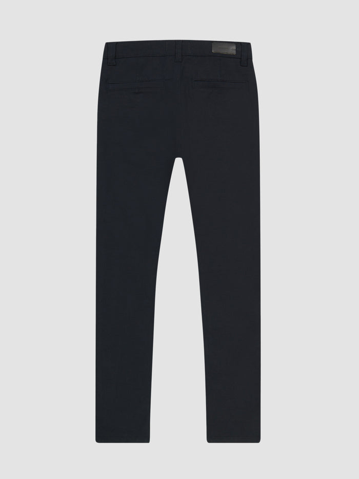 DL1961 boys' Brady Slim chino pants in dark navy 'Depths', flat back view with welt pockets.
