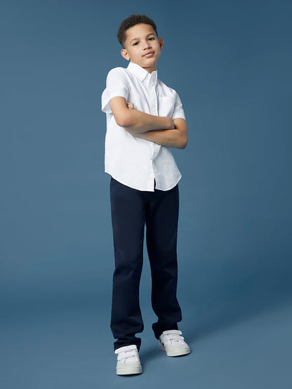 DL1961 boys' Brady Slim jeans in navy 'Dark Sapphire' on child model standing, arms crossed.