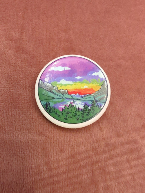 Rainbow St Mary button sticker by Sydney Boveng featuring colorful religious iconography on a round sticker.