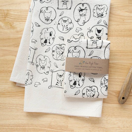 Cat kitchen tea towel with allover line-drawn cats in black on white cotton