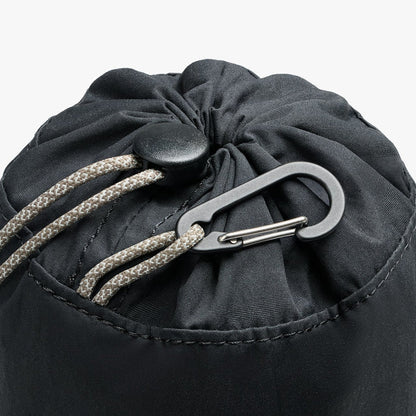 Black cinch pouch close-up: gathered top with braided drawcord and carabiner clip