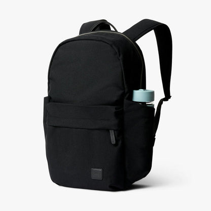 Black classic daypack with front zip pocket, top handle, and adjustable shoulder strap
