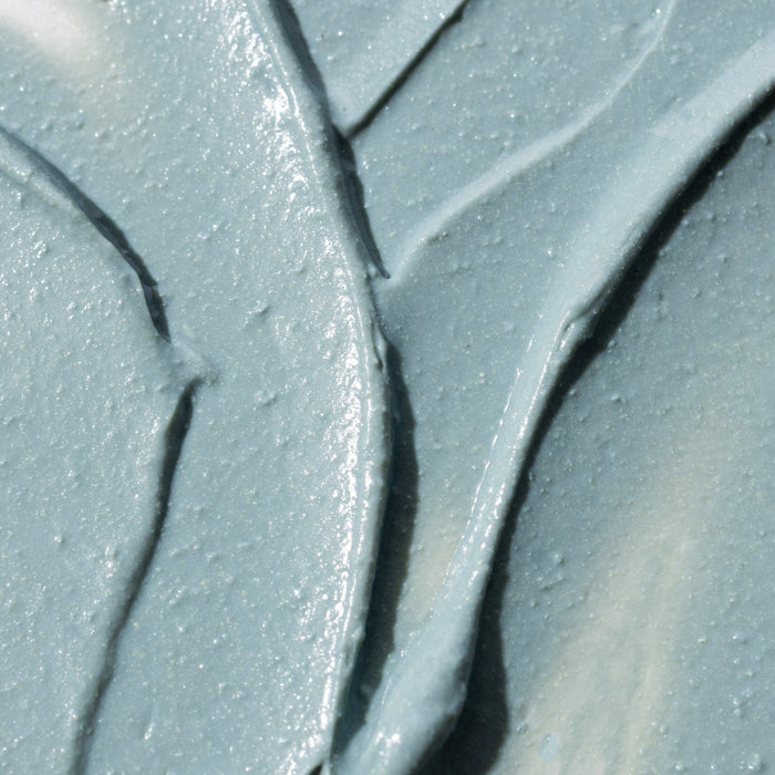 Macro view of a blue grey textured surface with glittery specks and grout lines