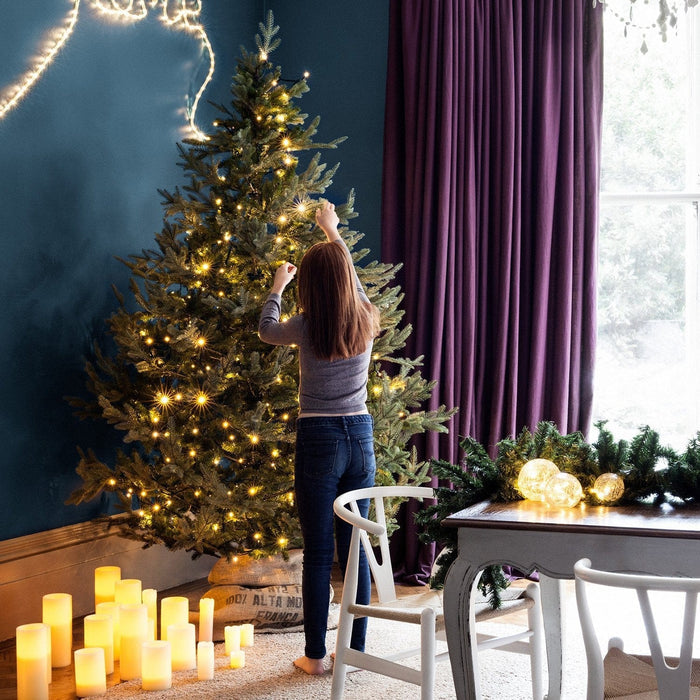 Indoor-Christmas-Lights-On-Artificial-Tree-With-Girl-Living-Room_13e2b583-38a6-4336-b439-125abce32fb8.jpg