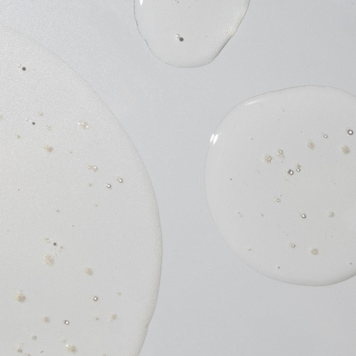 Macro close up of liquid droplets and circular patterns on a light surface evoking hydration for the Crystal Clear product