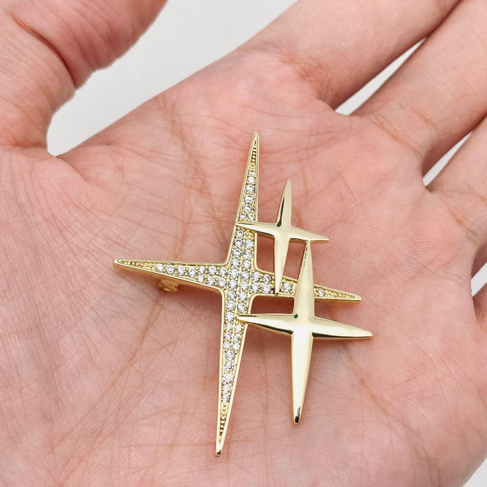 Mio Queena cubic zirconia star brooch pin with sparkling clear stones on silver-tone metal.