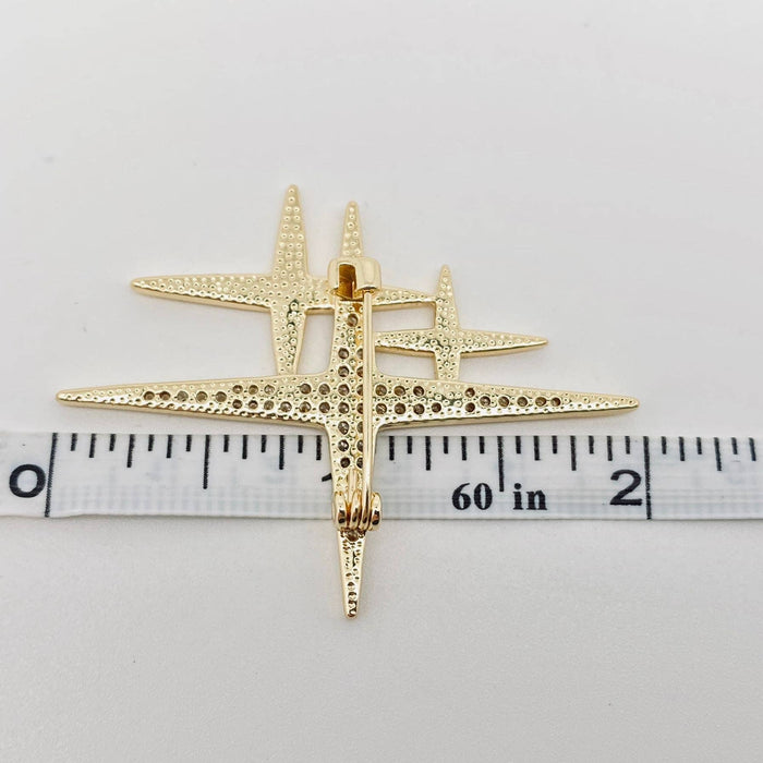 Mio Queena cubic zirconia star brooch pin with sparkling stones on a silver-tone metal background
