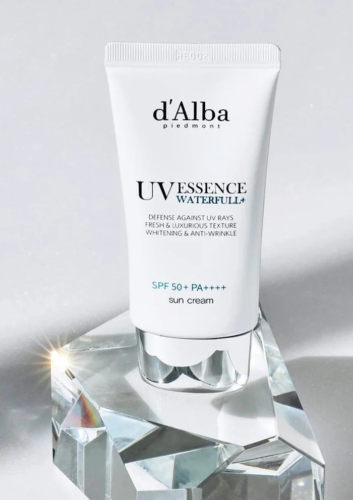 d'Alba UV Essence Waterfull+ sun cream on a crystal stand with a gray background
