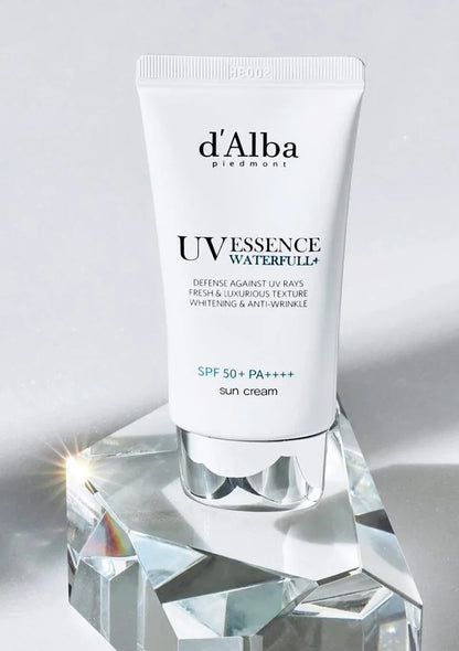 d'Alba UV Essence Waterfull+ sun cream on a crystal stand with a gray background
