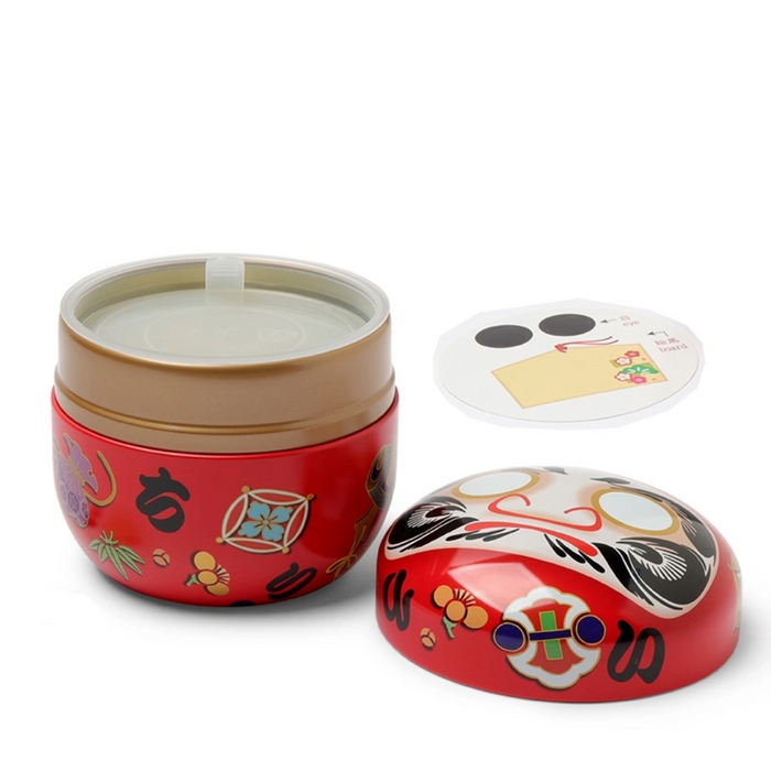 Open red daruma doll tea canister