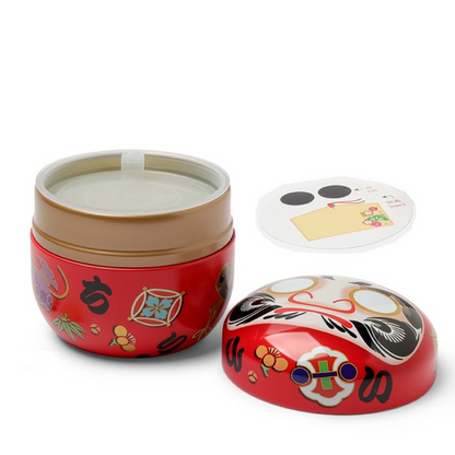 Open red daruma doll tea canister
