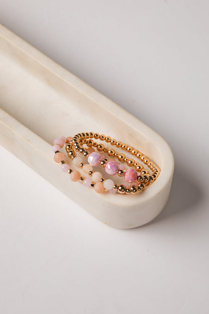Set of beaded bracelets on a white surface