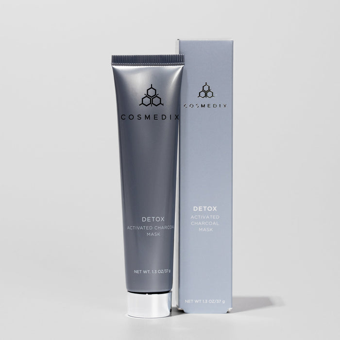 Detox Deluxe Travel Size activated charcoal mask tube beside a matching box with COSMEDIX logo
