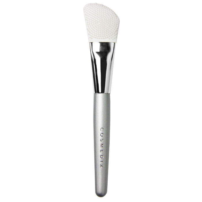 Dual-Sided Silicone Mask Applicator with textured and smooth head and curved silver handle.