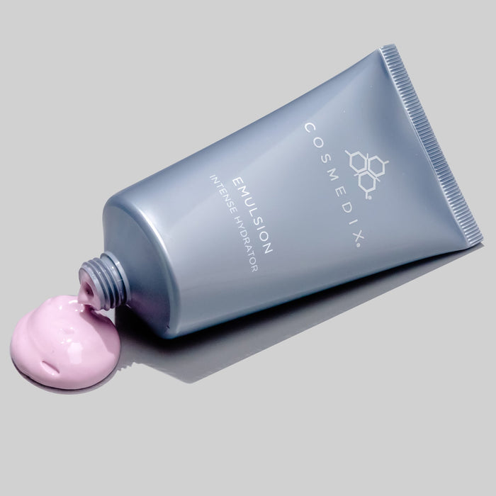 Emulsion Intense Hydrator tube laying flat against light gray background with pink product dripping