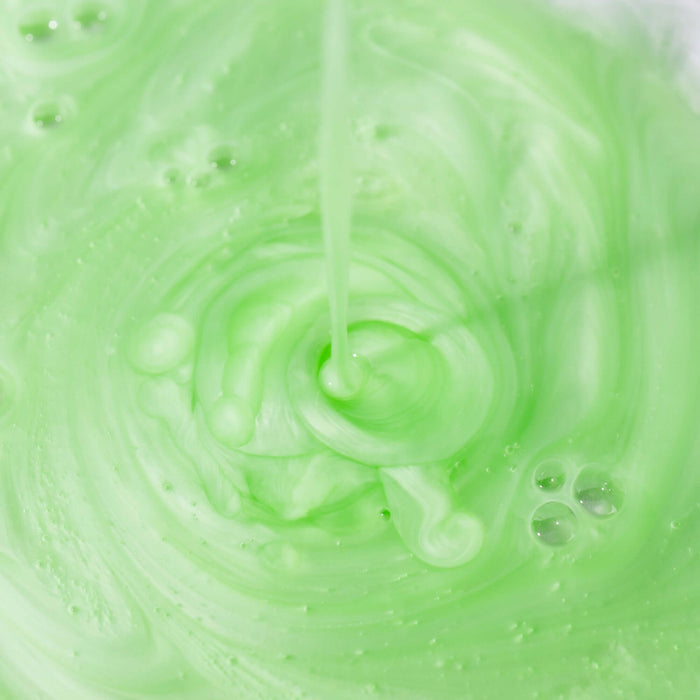 Close-up of green cleanser with swirling pattern