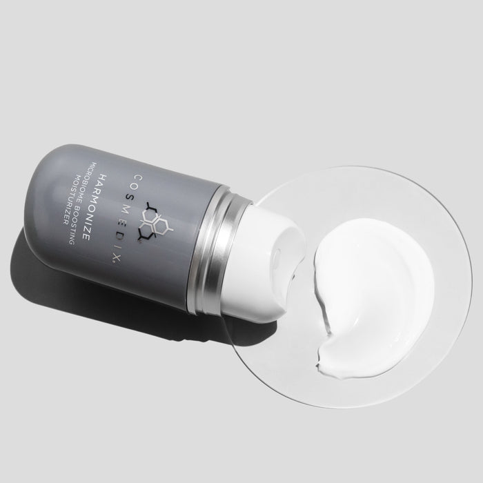 Cosmedix skincare product with cream on a gray background