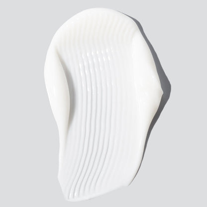 Harmonize moisturizer white lotion swatch closeup against white background