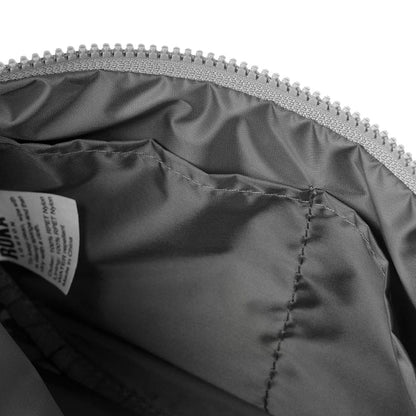 Half-moon bag interior lining with visible stitching and zip closure at top edge.
