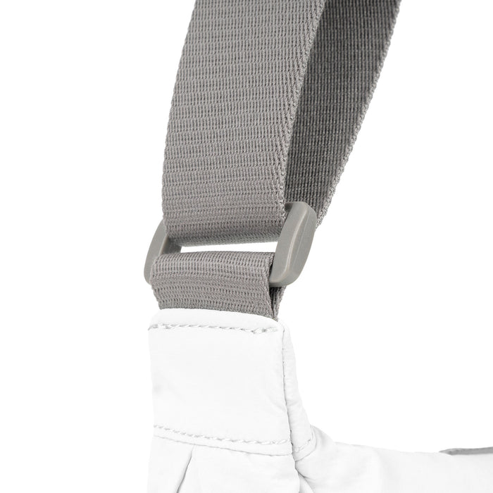 Coconut half-moon bag strap with gray webbing and stitched end attachment.