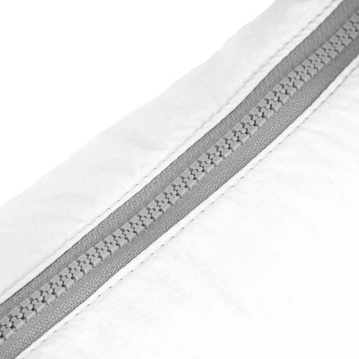 Coconut half-moon bag zip seam detail with gray zipper track and white fabric.