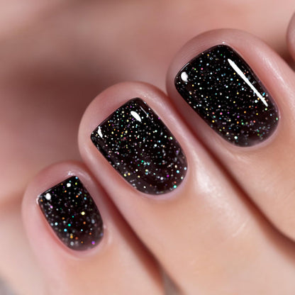 Galactic Spark black rainbow glitter manicure close-up short nails ultra-dense holographic iridescent sparkles