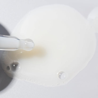 Close up of Fortify Cooling Enzyme Scalp Treatment showing a droplet on the dropper