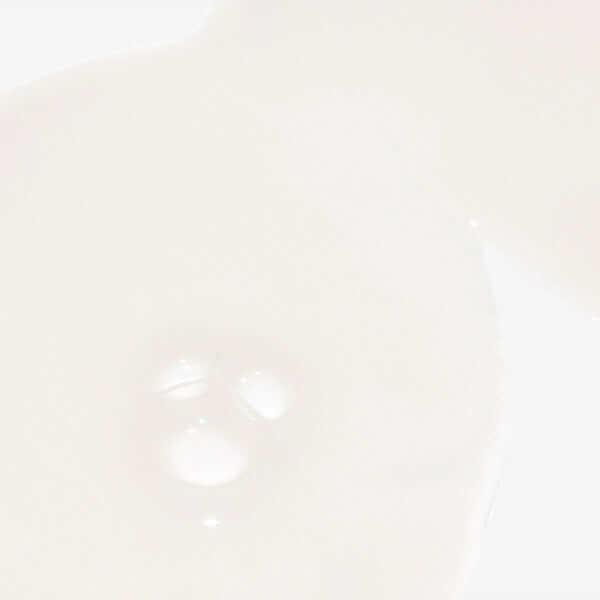 Creamy Fortify cooling enzyme scalp treatment on a clear glass dish against a pale background.